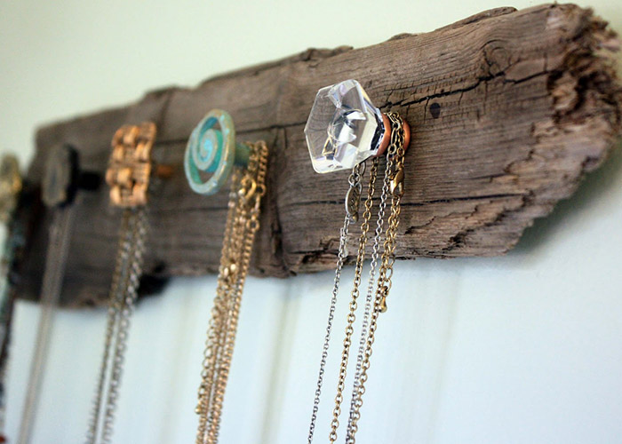 A DIY wood pallet jewelry holder used for necklace storage.