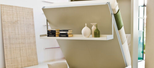 A Nuovoliola murphy bed from Resource Furniture that includes a sofa and storage shelf.