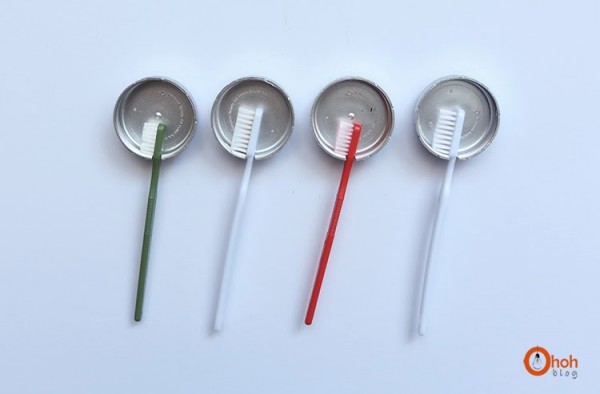 four bathroom wall-mounted diy toothbrush holders made from bottle caps