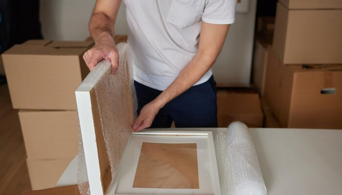 a man packing picture frames