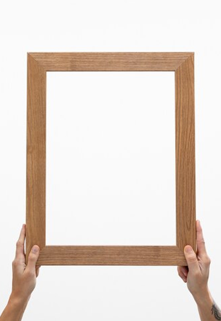 Two hands holding big wooden frame