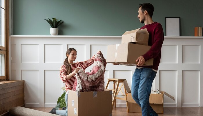 couple unpacking items in new home