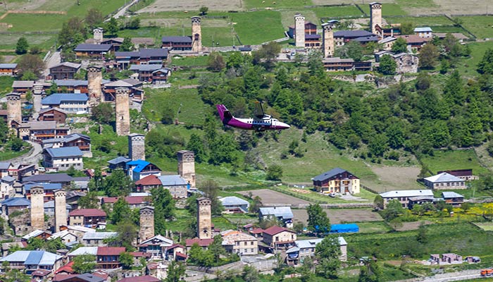 High angle view of houses and trees on field