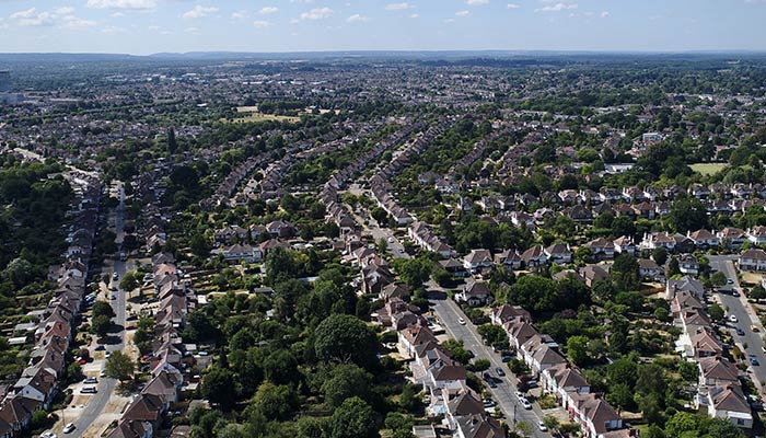 Panoramic shot of a cityscape with orderly streets and greenery