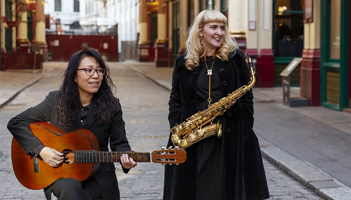 Medium shot musicians making jazz music outdoors