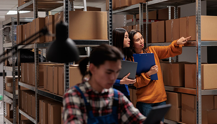 Storehouse employees checking package packing quality