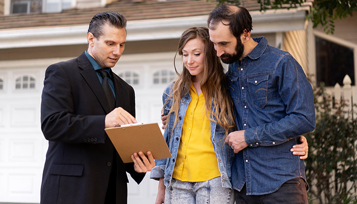 couple signing papers for house