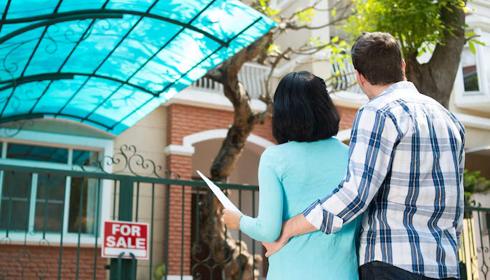 couple in front of the house