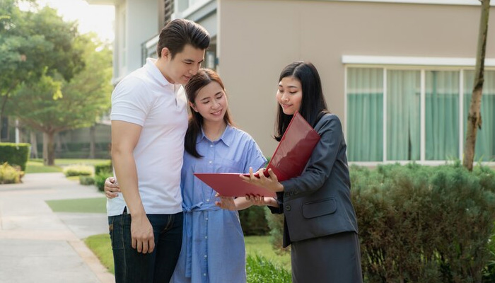 couple looking up for the details of house