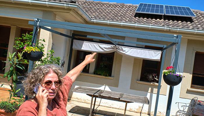 woman pointing on solar panel on the roof