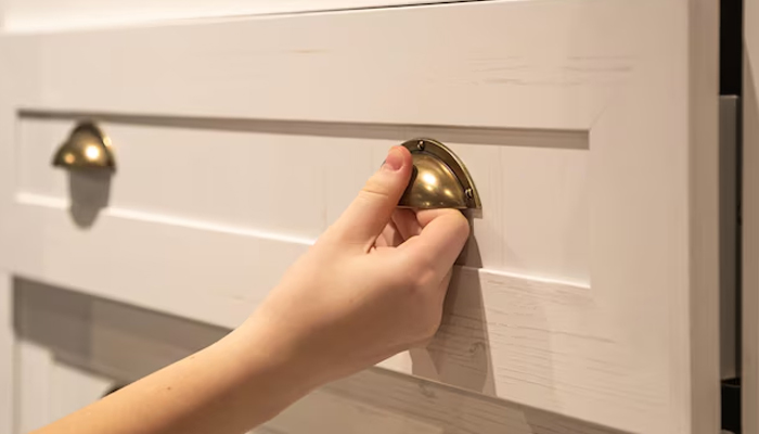 a woman pulling out a drawer