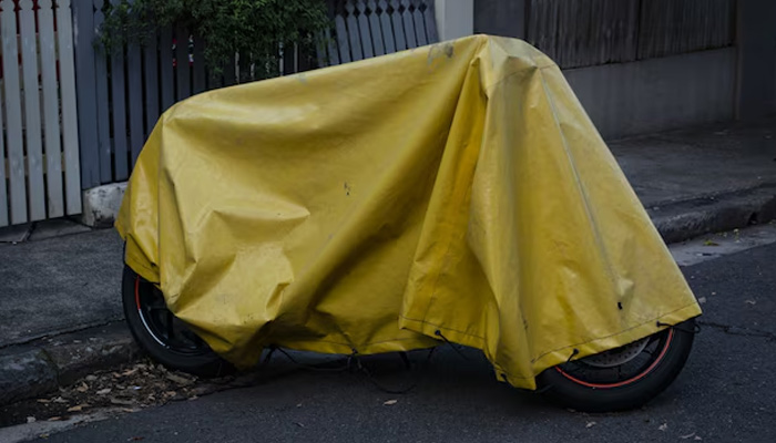 yellow tarp over motorcycle