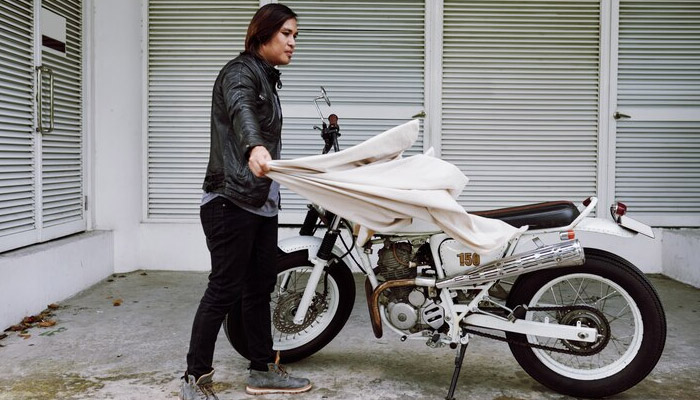 man removing motorcycle cover