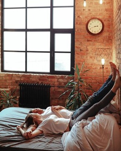 a couple in a room on the bed