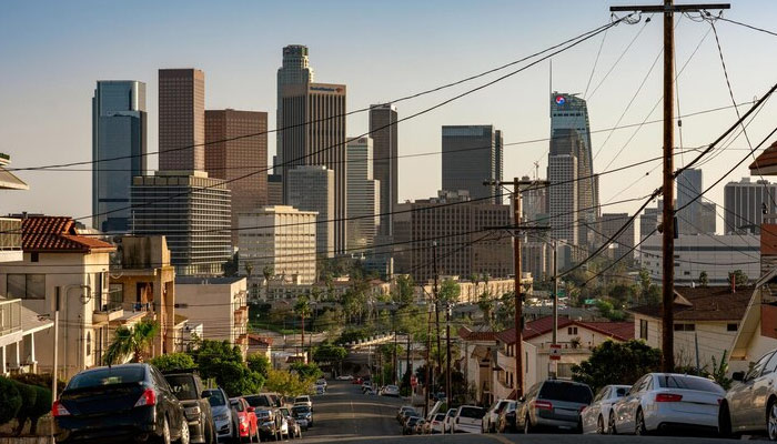 Cars parked on the road against buildings in the city during sunset