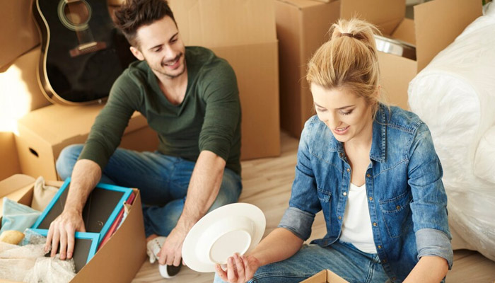 couple setting up kitchen items