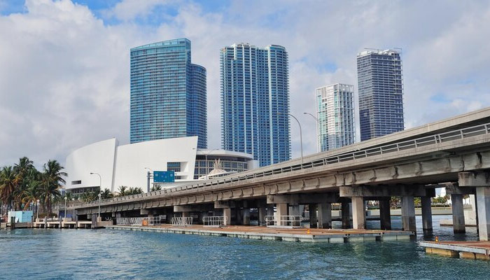 skyscrapers with a bridge over the sea in the day