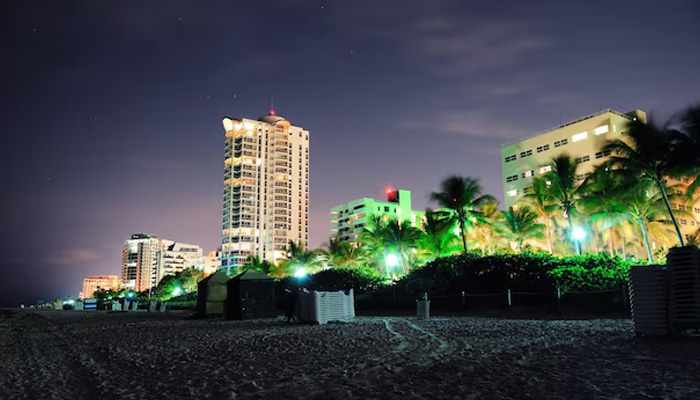 beach at night with residential buildings