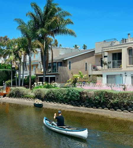 Scenic canal with boats and walkway