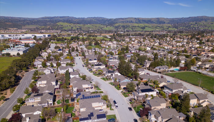 a neighborhood with hills in the background