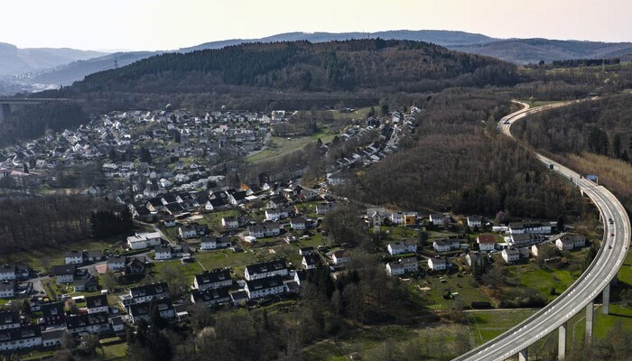 beautiful city surrounded by hills under the blue sky